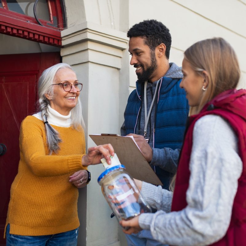 young-door-to-door-fundraisers-talking-to-senior-woman-and-collecting-money-for-charity-in-street.jpg young-door-to-door-fundraisers-talking-to-senior-woman-and-collecting-money-for-charity-in-street.jpg